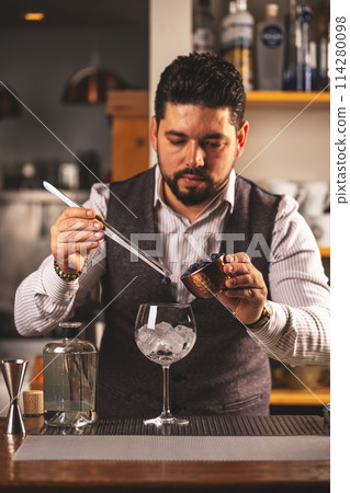 Professional bartender preparing a cocktail 114280098