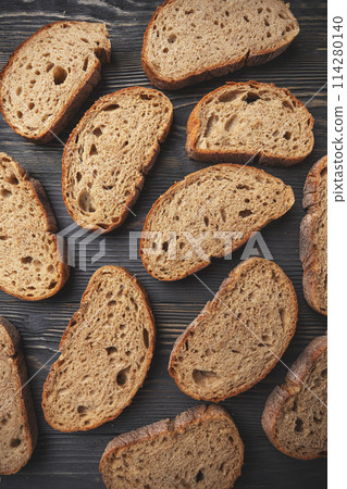 Artisan sliced bread on wooden surface 114280140
