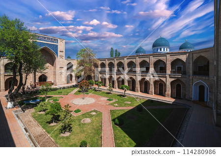 courtyard with cells of ancient Uzbek islamic Kukeldash madrasah in Tashkent in Uzbekistan. Old medieval Islamic madrassa in spring 114280986