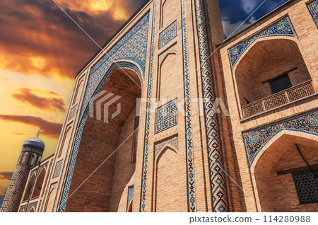 portal of ancient medieval Uzbek Islamic Kukeldash madrasah in Tashkent in Uzbekistan. Old madrasa in Asia at sunset 114280988