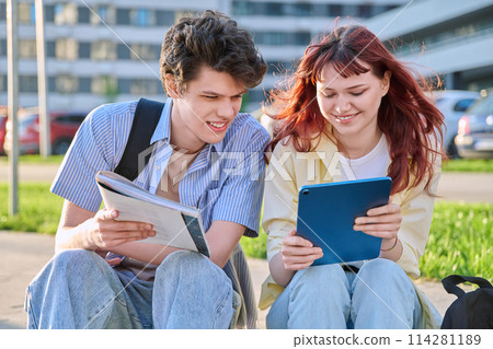 Teenage college students guy and girl talking, sitting outdoor 114281189