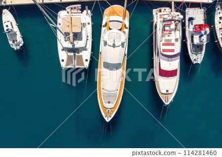 Scenic aerial view many yachts boats moored at Croatian bay harbor shore blue turquoise clear water at bright summer sunny day. Top above Mediterranean sea marina. Boat vessel charter service 114281460