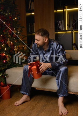 A happy family poses in pajamas in New Year's locations. A happy family poses in pajamas in New Year's locations. 114281697