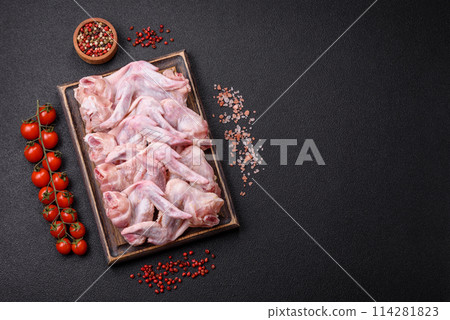Fresh chicken wings with salt, spices and herbs Fresh chicken wings with salt, spices and herbs 114281823