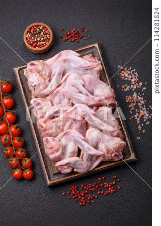 Fresh chicken wings with salt, spices and herbs Fresh chicken wings with salt, spices and herbs 114281824