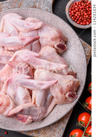 Fresh chicken wings with salt, spices and herbs Fresh chicken wings with salt, spices and herbs 114281834