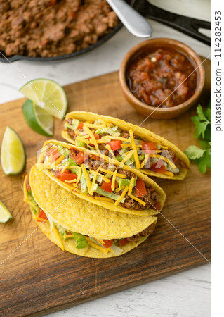 yellow hard shell tacos on cutting board yellow hard shell tacos on cutting board 114282453