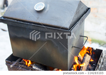 Outdoor Smoker on Fire Cooking Food Outdoor Smoker on Fire Cooking Food 114283103