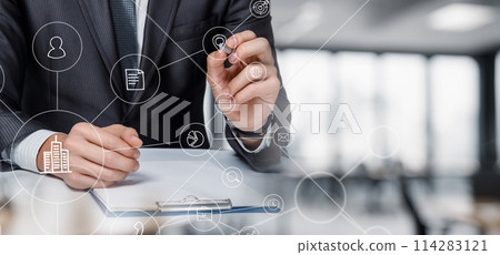 A businessman draws the structure of a business process. 114283121