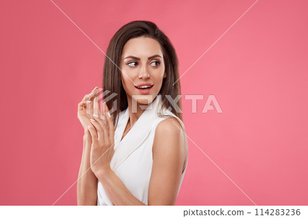 Shocked and surprised girl screaming covering mouth her hands.Beautiful Woman in black dress.Presenting your product.Expressive facial expressions emotions 114283236