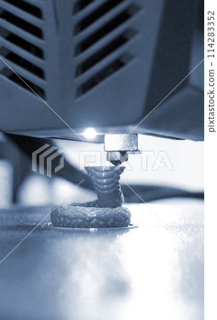3D printer. 3D printing. 3d printer printing process close-up. 3D printer creating object from molten plastic. Modern three-dimensional printing technologies. Innovation additive robotic technology 3D printer. 3D printing. 3d printer printing process close-up. 3D printer creating object from molten plastic. Modern three-dimensional printing technologies. Innovation additive robotic technology 114283352