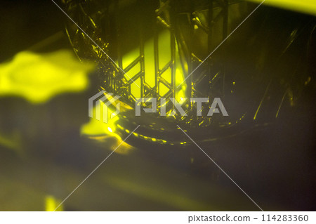 Working of photopolymer sla 3D printer. Platform with building object lowered into liquid photopolymer resins and hardened under ultraviolet laser. Progressive additive technology. 3D printer printing Working of photopolymer sla 3D printer. Platform with building object lowered into liquid photopolymer resins and hardened under ultraviolet laser. Progressive additive technology. 3D printer printing 114283360