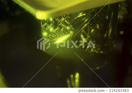 Working of photopolymer sla 3D printer. Platform with building object lowered into liquid photopolymer resins and hardened under ultraviolet laser. Progressive additive technology. 3D printer printing 114283363