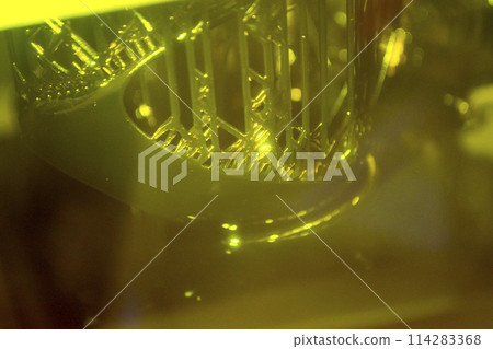 Working of photopolymer sla 3D printer. Platform with building object lowered into liquid photopolymer resins and hardened under ultraviolet laser. Progressive additive technology. 3D printer printing 114283368