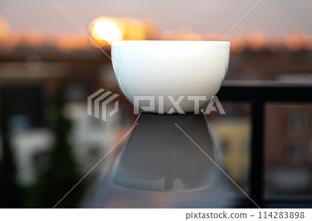 White ceramic bowl reflecting on a black wet surface, Belgium White ceramic bowl reflecting on a black wet surface, Belgium 114283898
