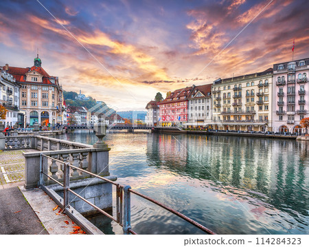 Fabulous historic city center of Lucerne with famous buildings and calm waters of Reuss river. 114284323