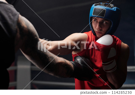 Kicking rival in protective helmet 114285230
