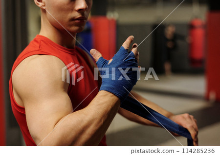 Putting protective band around hand Putting protective band around hand 114285236