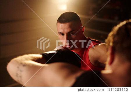 Boxer looking at rival during kick Boxer looking at rival during kick 114285330