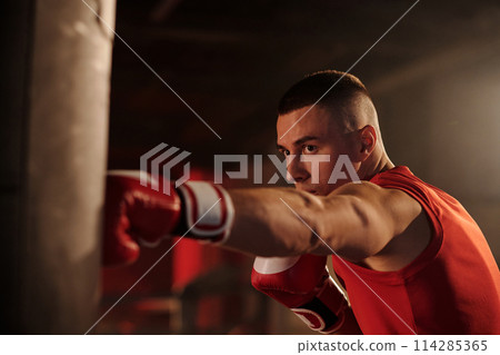 Man practicing basic boxing technique 114285365