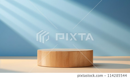 Beautiful round wooden podium, pedestal for an object against a background of a blue sunny wall.  114285544