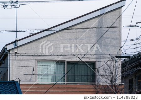 Two-storey detached house with a sloping roof Two-storey detached house with a sloping roof 114288828