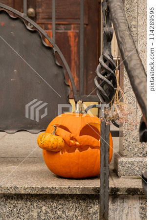 Halloween decorated outdoor cafe or restaurant terrace in America or Europe with carved pumpkins traditional attributes of Halloween. Frontyard decoration 114289596