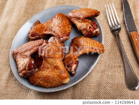 Smoked chicken wings served on platter Smoked chicken wings served on platter 114289641