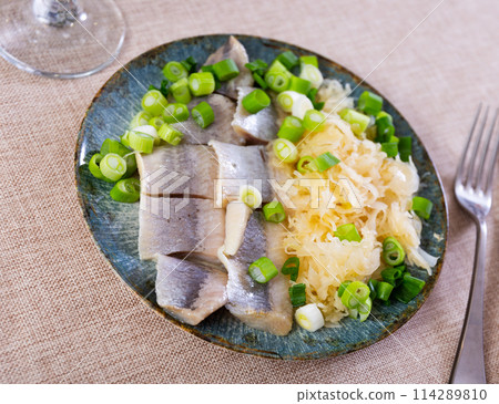 Sliced herring served with sauerkraut Sliced herring served with sauerkraut 114289810