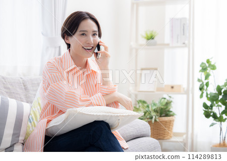 A woman talking on a smartphone 114289813