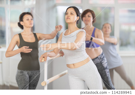 Asian woman refining ballet technique with emale instructor Asian woman refining ballet technique with emale instructor 114289941