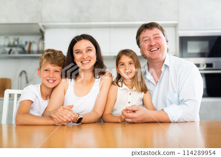 Happy family with two children posing in kitchen Happy family with two children posing in kitchen 114289954