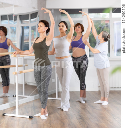 Elderly woman teacher correcting female dancers 114290306