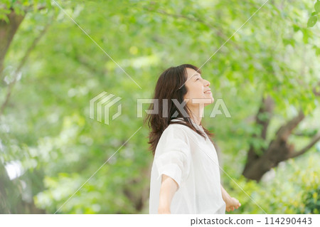Middle-aged woman in a white shirt Middle-aged woman in a white shirt 114290443