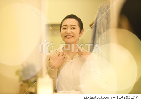 Middle-aged woman doing night skin care 114293177