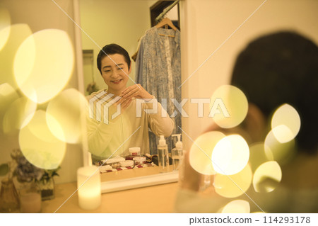 Middle-aged woman doing night skin care 114293178