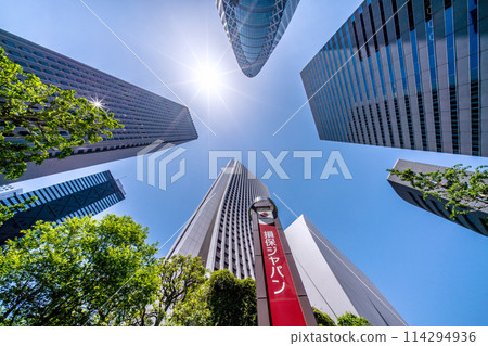 Tokyo cityscape in Japan. View of Shinjuku's skyscrapers and sunlight. In front is the Sompo Japan Nipponkoa headquarters building. 114294936