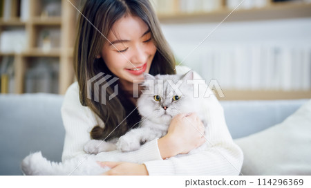 Portrait of young Asian woman holding cute cat Portrait of young Asian woman holding cute cat 114296369
