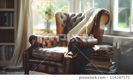 Classic leather club chair by a window with mixed soft sunlight and white light illuminating a side table with books, creating an elegant and tranquil reading nook 114297572