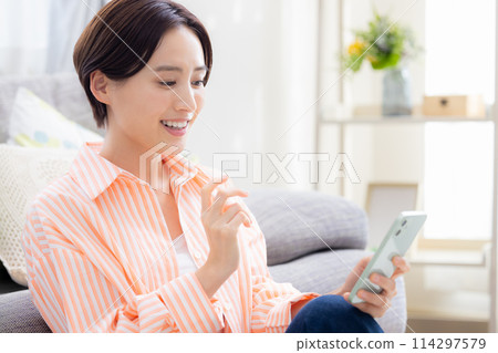 A woman looking at a smartphone 114297579