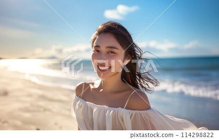 A woman in a white dress on the beach 114298822