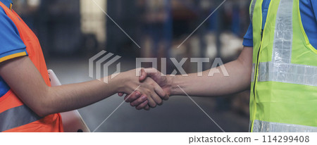Banner Asian Teamwork Warehouse worker shakehand together. Engineer man, women handshake partnership. Coworker colleague logistics Warehouse teams. Team person shaking hand partner with copy space 114299408