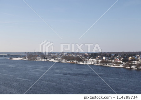 river on a sunny evening. Trees and shrubs. Landscape of winter nature, river banks  114299734