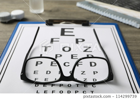 Glasses with a label for a paper vision test Glasses with a label for a paper vision test 114299739