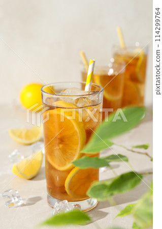 A glass of cold tea with fresh orange slices 114299764