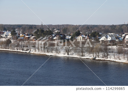 river on a sunny evening. Trees and shrubs. Landscape of winter nature, river banks  114299865