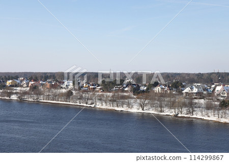 river on a sunny evening. Trees and shrubs. Landscape of winter nature, river banks  114299867