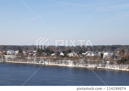 river on a sunny evening. Trees and shrubs. Landscape of winter nature, river banks  114299874