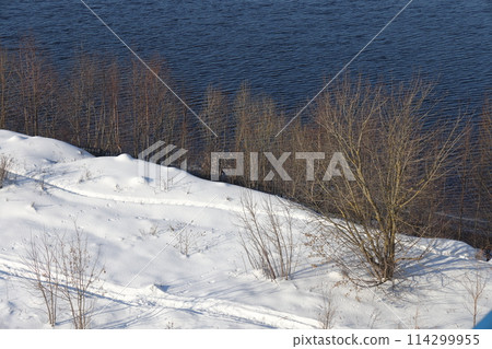 river on a sunny evening. Trees and shrubs. Landscape of winter nature, river banks  114299955