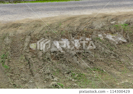 Tire marks on a muddy road. Dirty country road with deep rut 114300429
